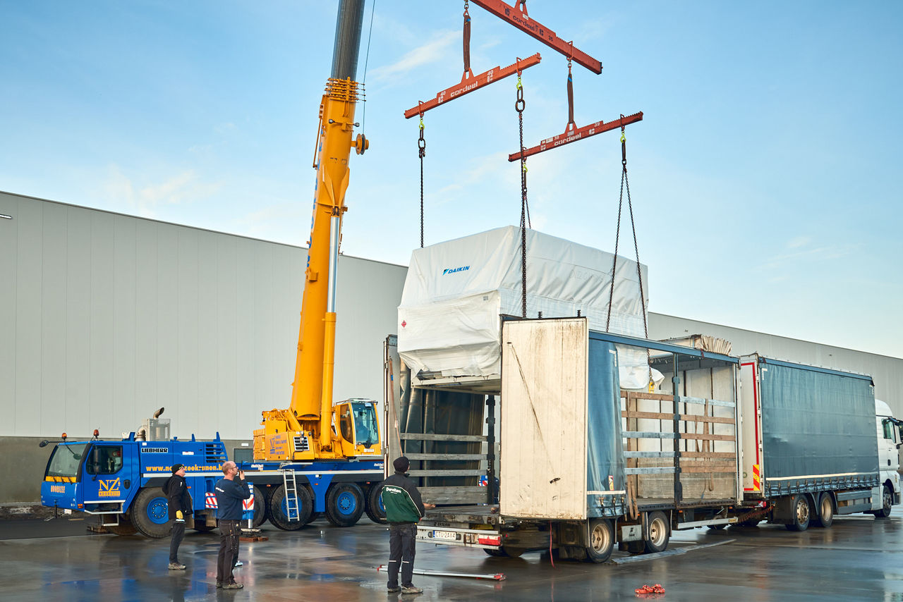 Crane lifting a HVAC unit for replacement