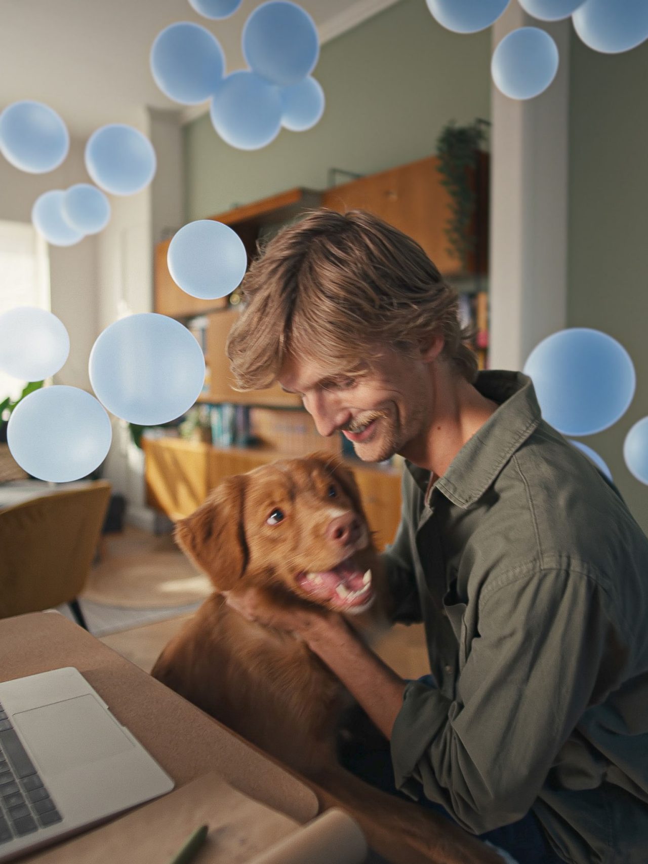 Young man at his desk with his dog, enjoying quiet comfort and smart climate control