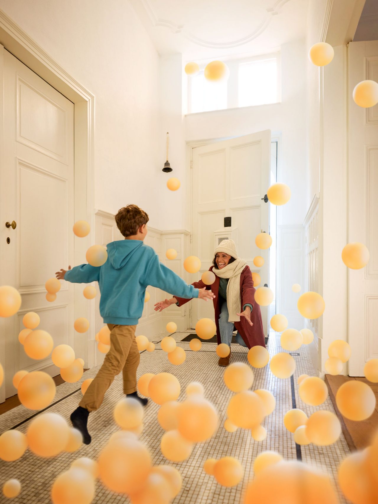 Son embracing his mother in a welcoming hallway, symbolising the comfort, warmth, and invisible impact of clean, perfectly balanced indoor air by Daikin