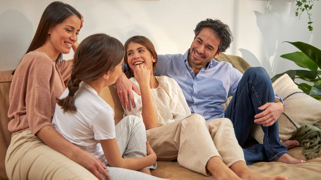 Happy family relaxing on the couch in a perfectly climate-controlled home
